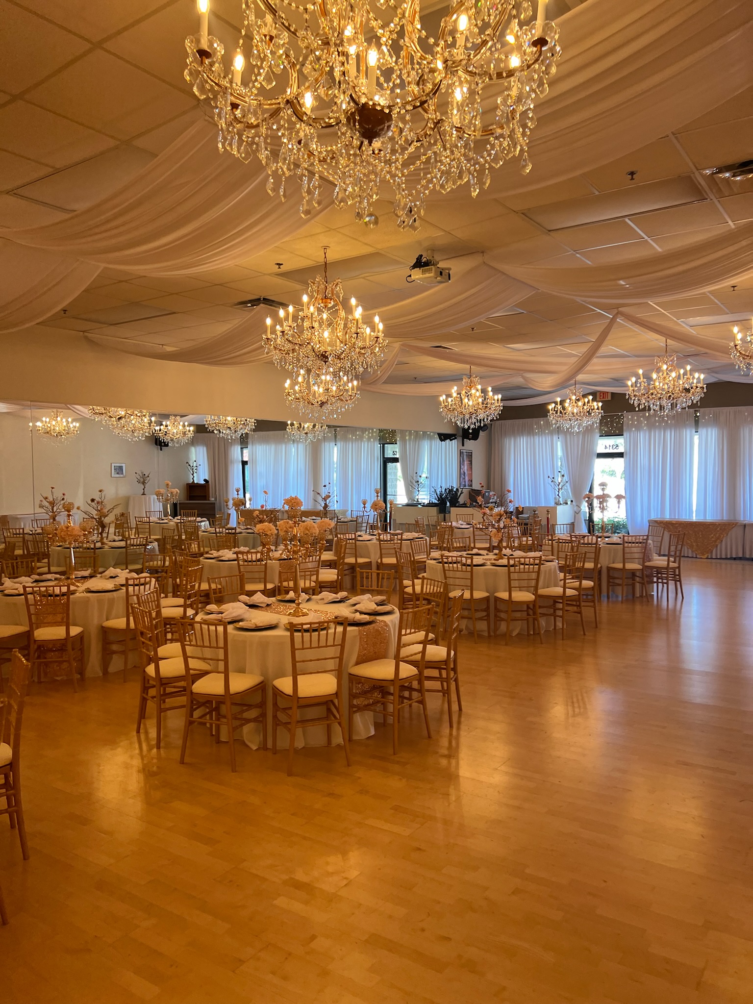 Warm chandelier ballroom setup at Nencini Ballroom